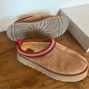 UGG Tazz slip-ons in Chestnut with red trim.